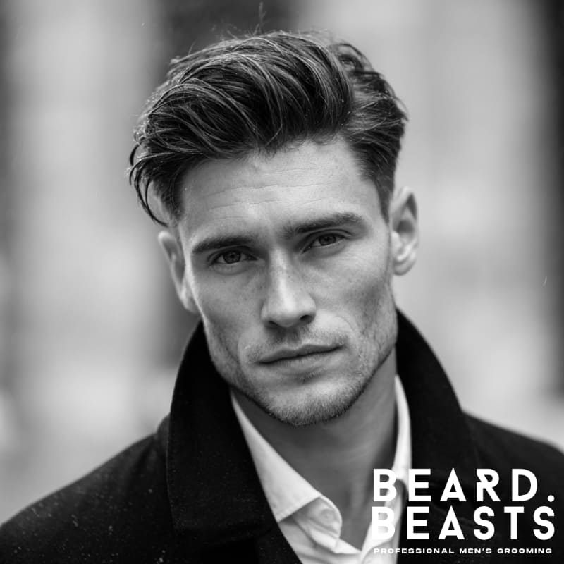 Portrait of a man showcasing a side part with soft sweep, an elegant and balanced men's haircut ideal for square face shapes.