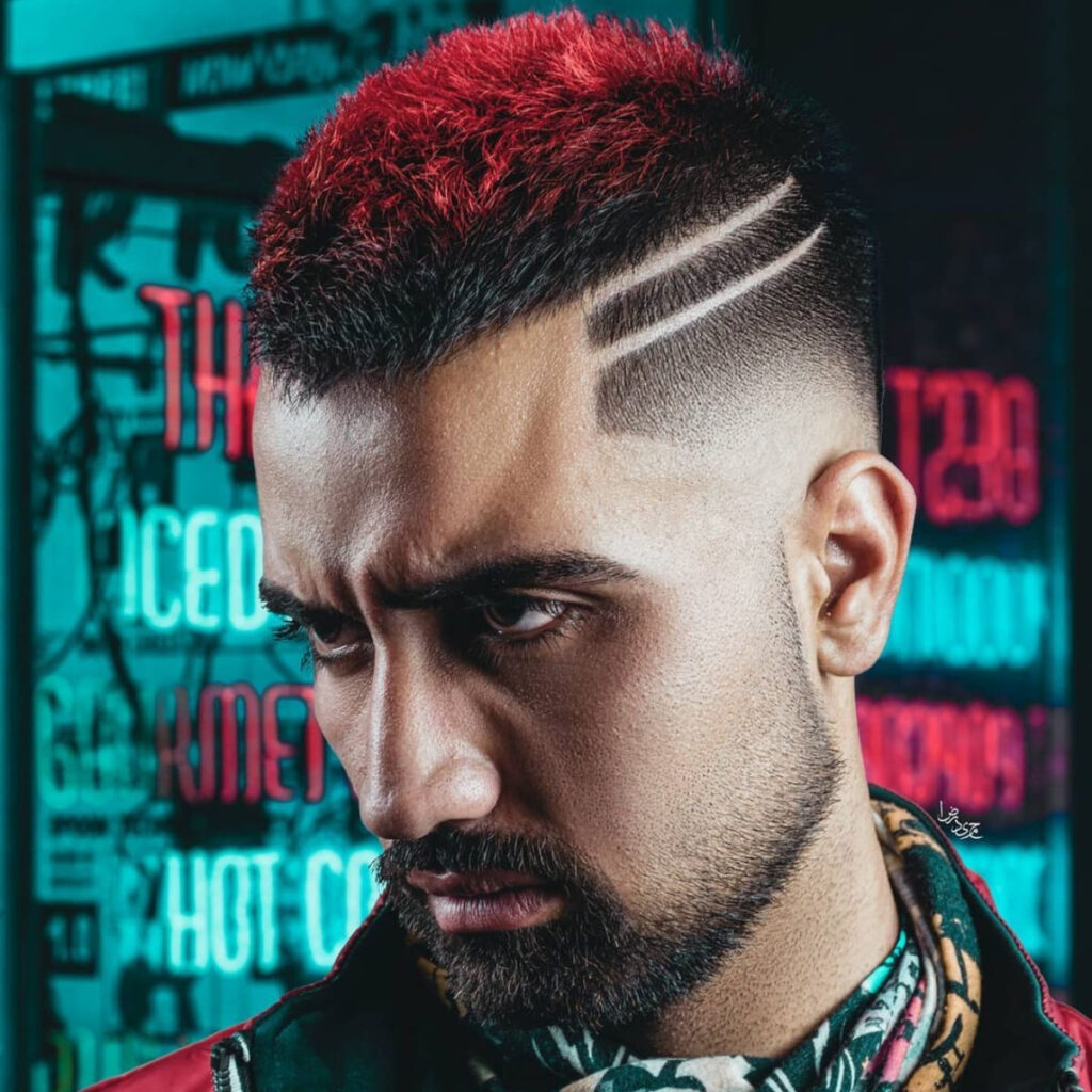 Close-up of a man with a bold haircut featuring intricate shaved designs. The style includes sharply tapered sides, paired with two parallel shaved lines above the ear, creating a unique and artistic look. The vibrant, red-dyed textured top contrasts strikingly with the clean taper and designs, making this style a standout choice for anyone wanting a modern, edgy hairstyle that reflects personality.