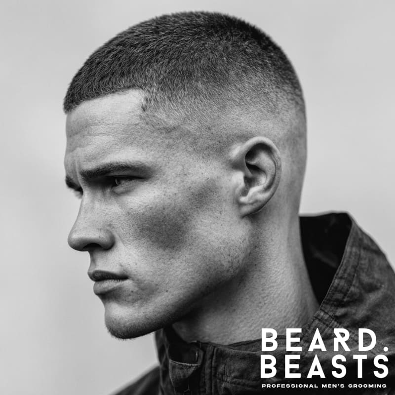 Skin fade buzz cut with a high fade on the sides, creating a sharp and clean look.