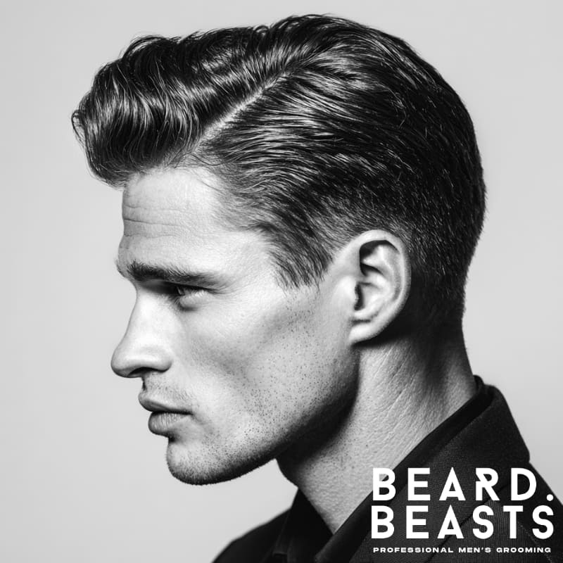 Man with a classic side part quiff—clean part on the left, brushed-back top, and neatly tapered sides.