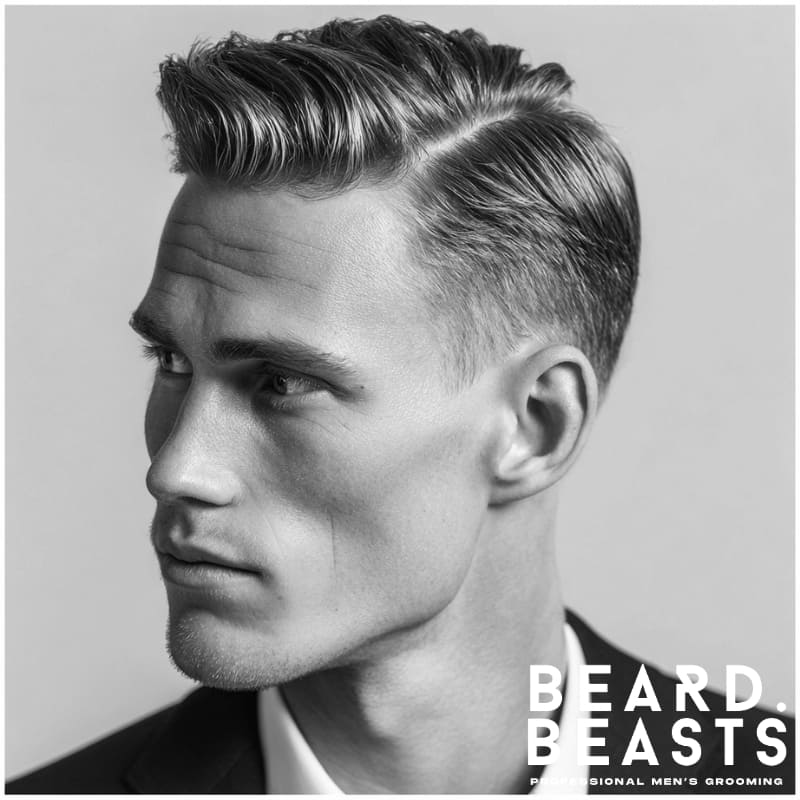 Man with a side part quiff—low fade above the ears, defined part, and structured volume on top.