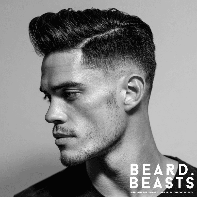 Side-part skin fade pompadour with clean fade on the sides, sharp side part, and voluminous top styled for a polished, sophisticated look.