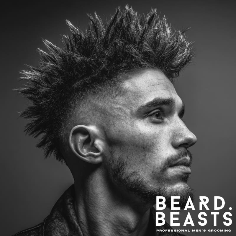 Skin fade faux hawk hairstyle featuring bold, spiked hair on top and a sharp fade on the sides.