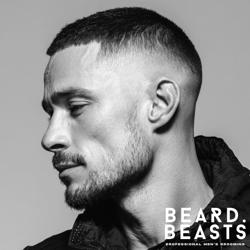 Crew cut hairstyle with a high fade on the sides, featuring short, uniform hair on top. A clean and sharp example of skin fade haircuts with a polished, professional look.