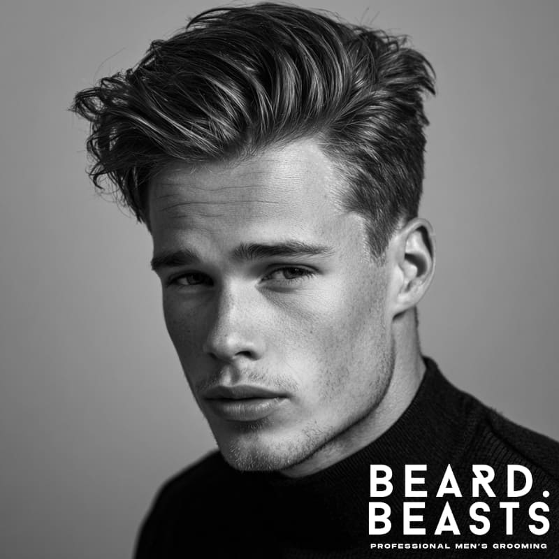 Man with a textured side part quiff—matte finish with natural separation and soft taper on the sides.