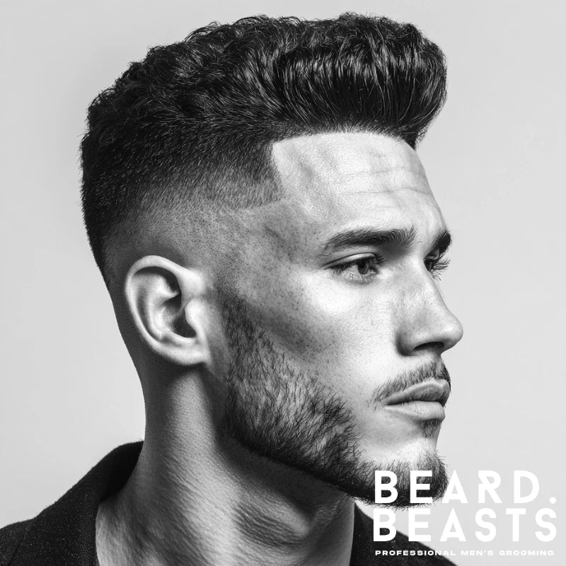 Bald drop fade with a voluminous pompadour, creating a striking contrast between the elevated top and clean tapered sides. This dramatic look adds height and structure, perfect for those seeking a bold, timeless style.