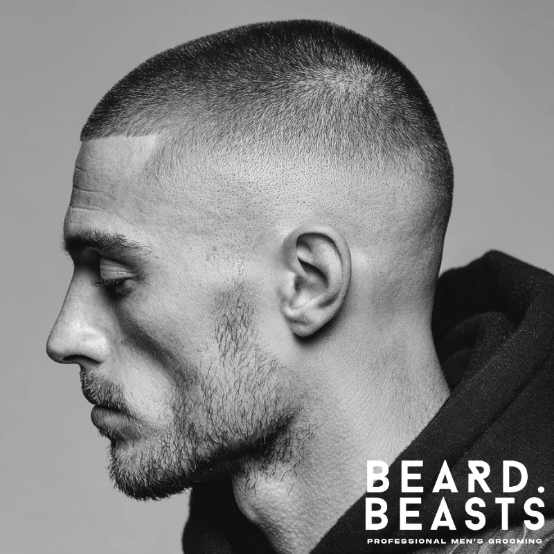 Buzz cut paired with a bald drop fade, featuring a clean, sharp fade around the ears and a uniform buzzed top. This low-maintenance style offers a defined, structured look ideal for men on the go.