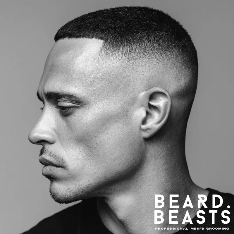 Classic bald drop fade haircut with clean, tapered sides and a sharp drop around the ear, offering a sleek and professional appearance for modern men.