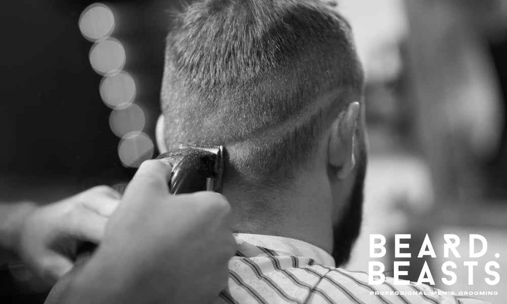 Close-up of a man getting his hair styled by a professional barber in a barbershop, showcasing a barber's skillful technique with clippers.