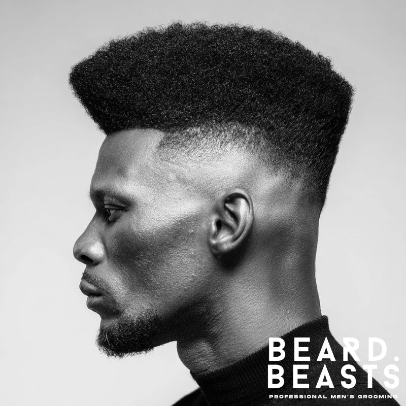 High-top fade with voluminous textured hair on top, creating a bold, modern look. The clean fade around the sides adds definition while the height of the top provides a unique, standout style.