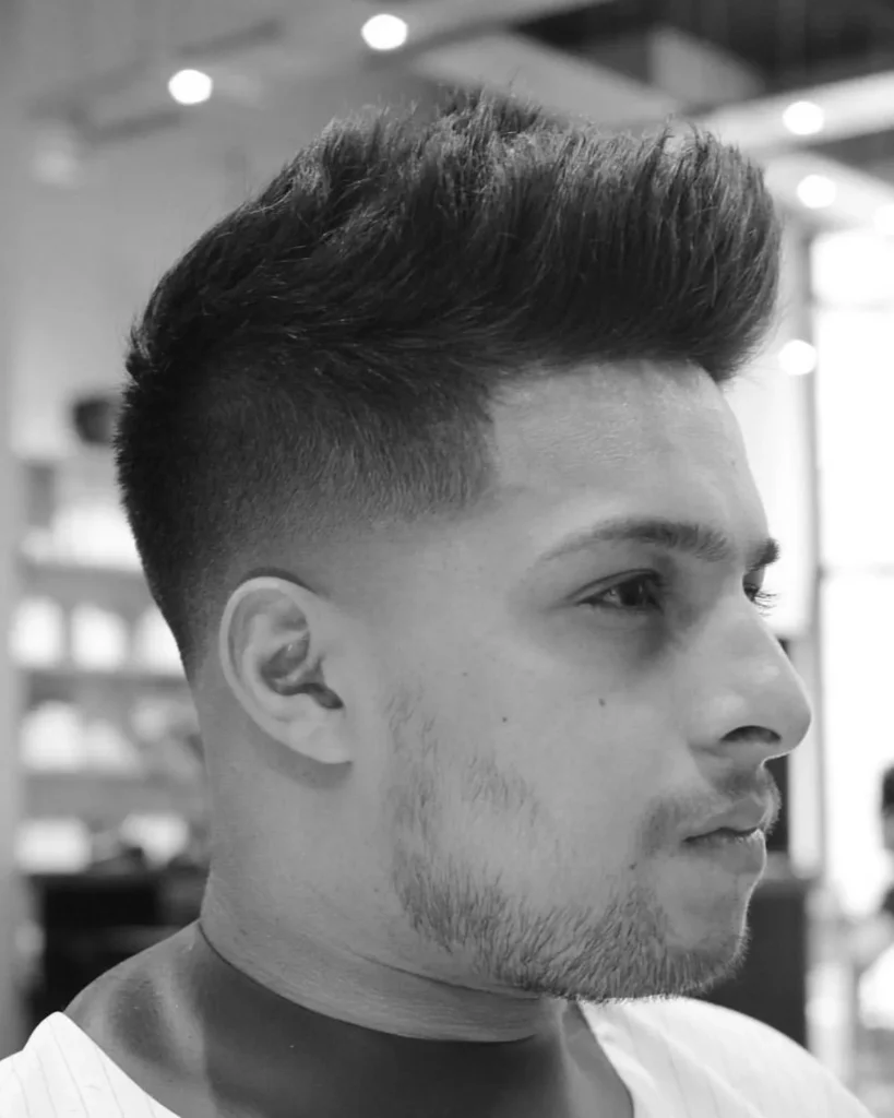 low fade short textured quiff haircut with mid fade and textured top, three-quarter view