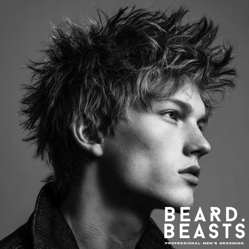 Messy spiky tousled look on a model, featuring natural, textured spikes and a carefree, voluminous style. The hair is styled in a relaxed, messy fashion, creating an effortless yet edgy appearance.