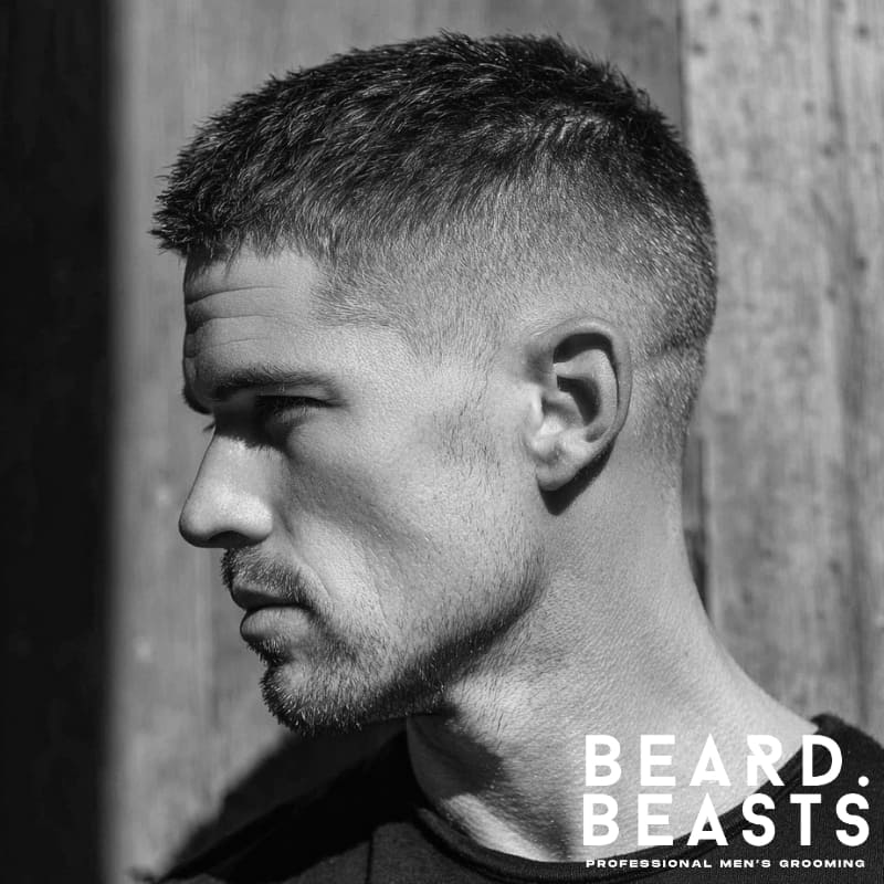 Young male model with a textured crew cut haircut for men, featuring short sides and natural texture on top for a clean, sharp look.