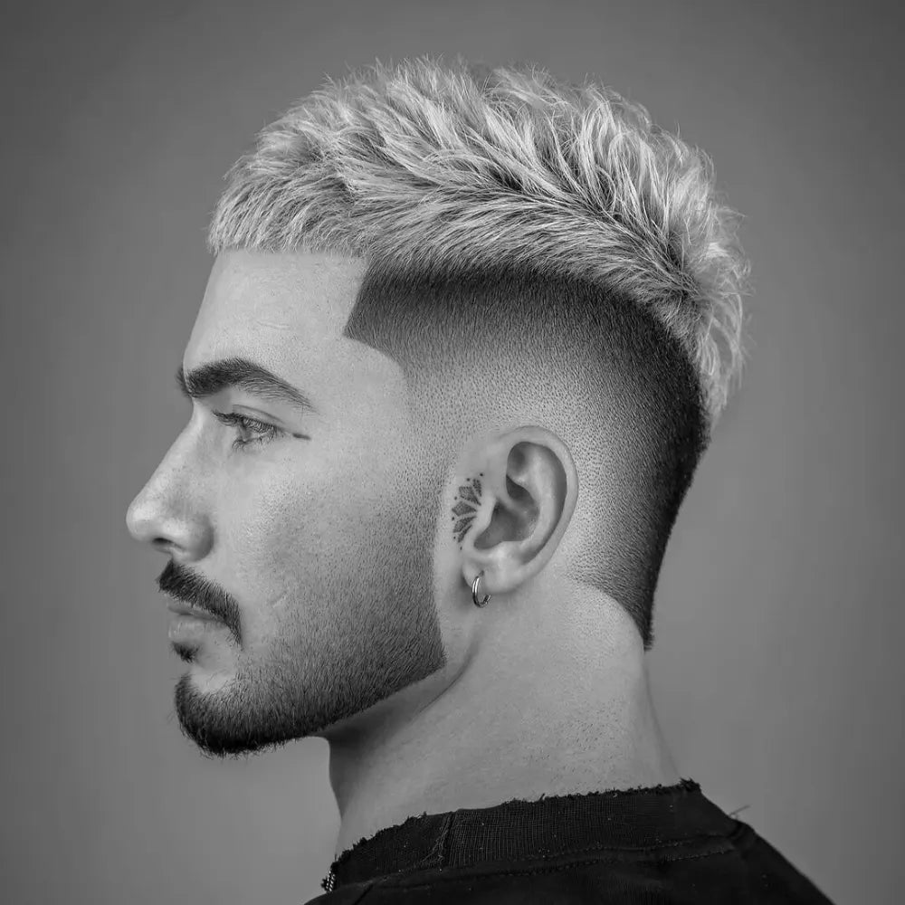 Men’s textured crop haircut with burst fade, featuring short layered top and sharp faded sides.
