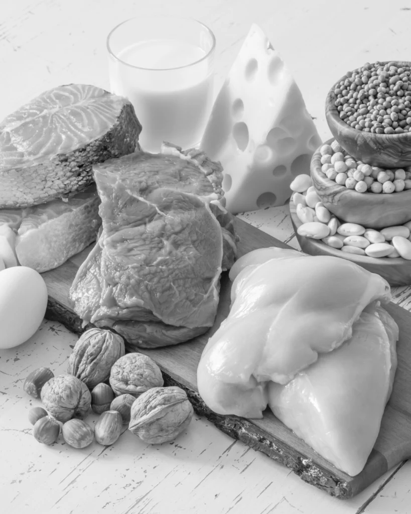Protein-rich foods including eggs, fish, chicken, beef, nuts and beans, showing how diet can support healthier beard growth and thicker-looking facial hair.