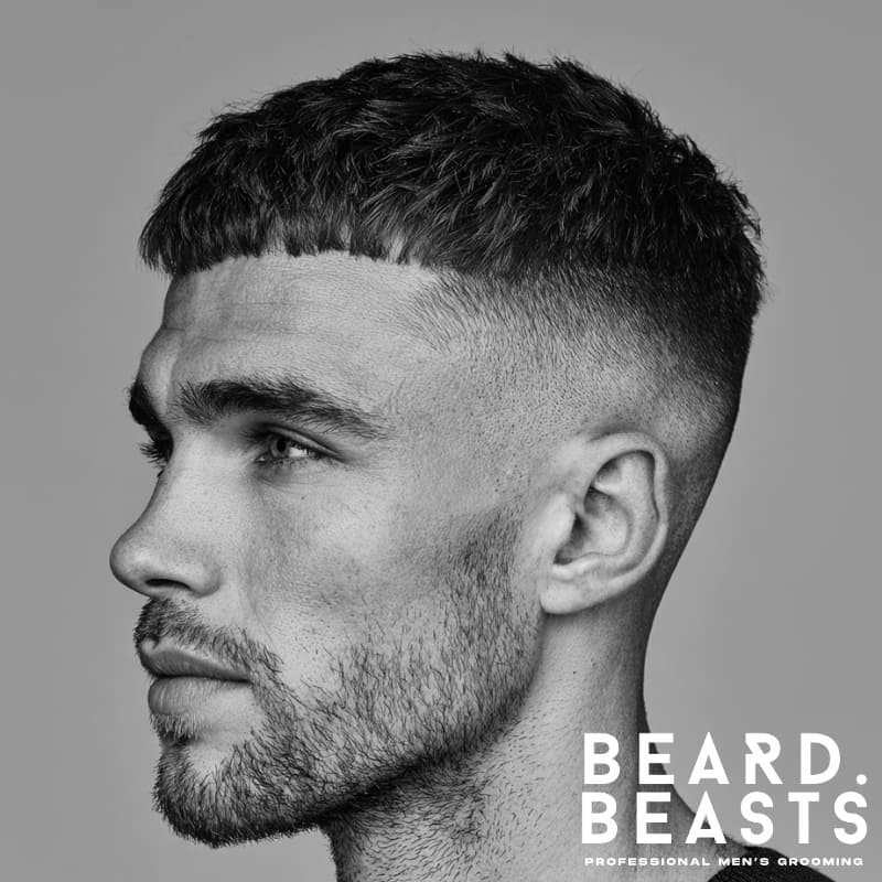 French crop hairstyle for men with a clean mid-skin fade, featuring a short, cropped fringe and sharp contrast between the top and sides.