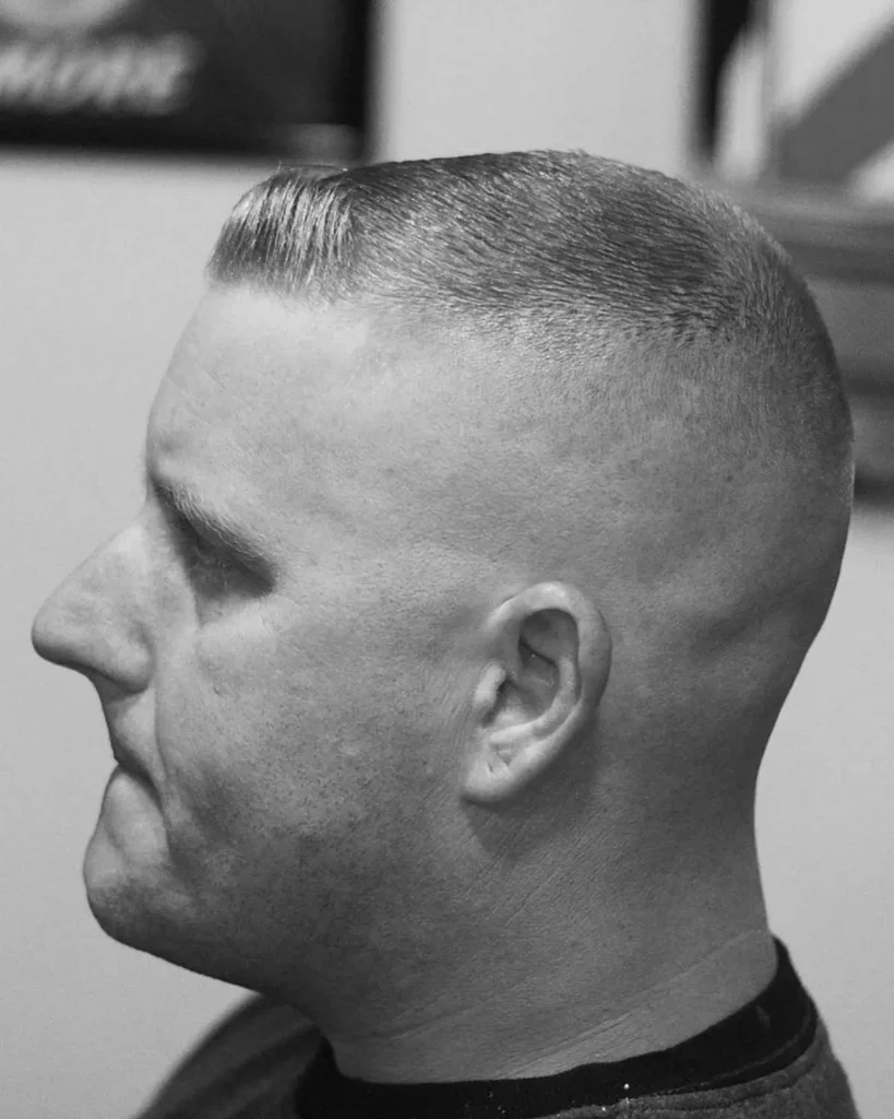 high and tight haircut with skin fade sides and slicked flat top, side profile view