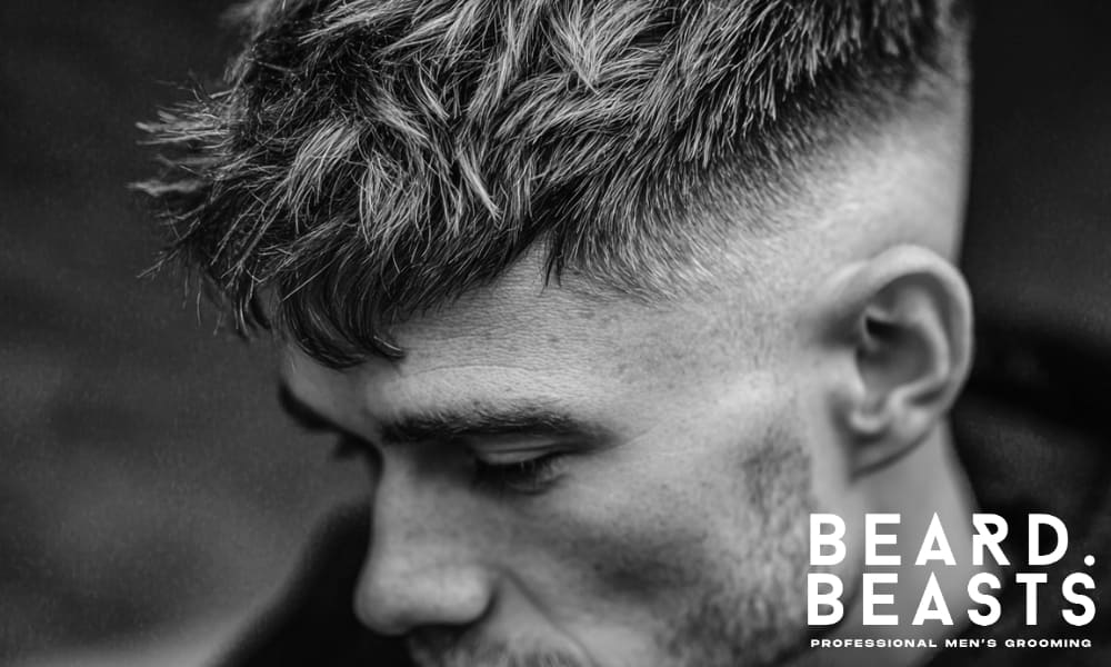 Textured hairstyle with voluminous top and clean sides, showcasing a modern, edgy look.