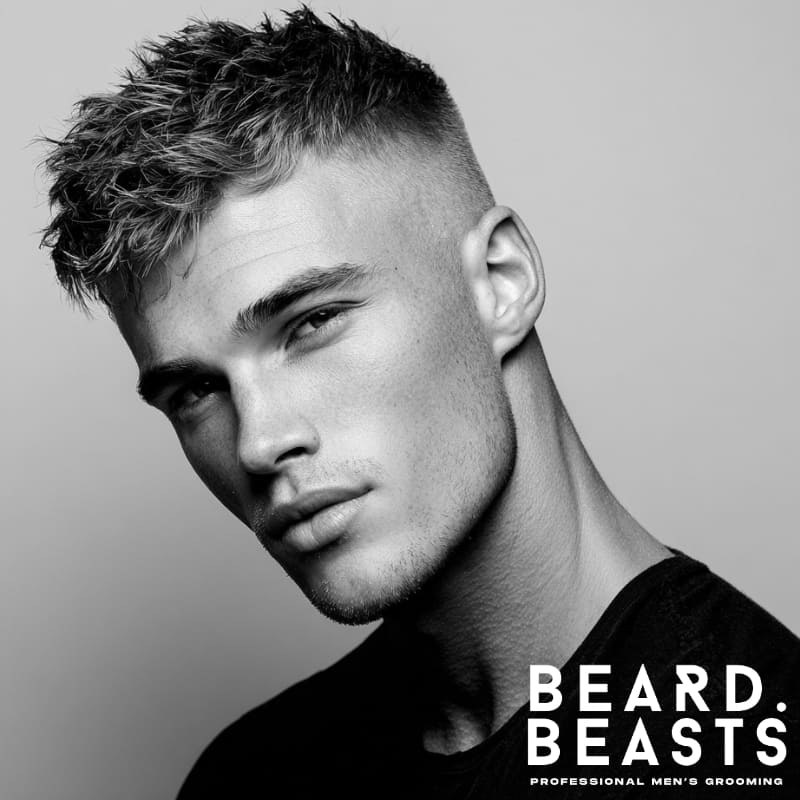 Textured high fade fringe haircut for men, showcasing voluminous top with clean fade sides, ideal for a modern, edgy look.