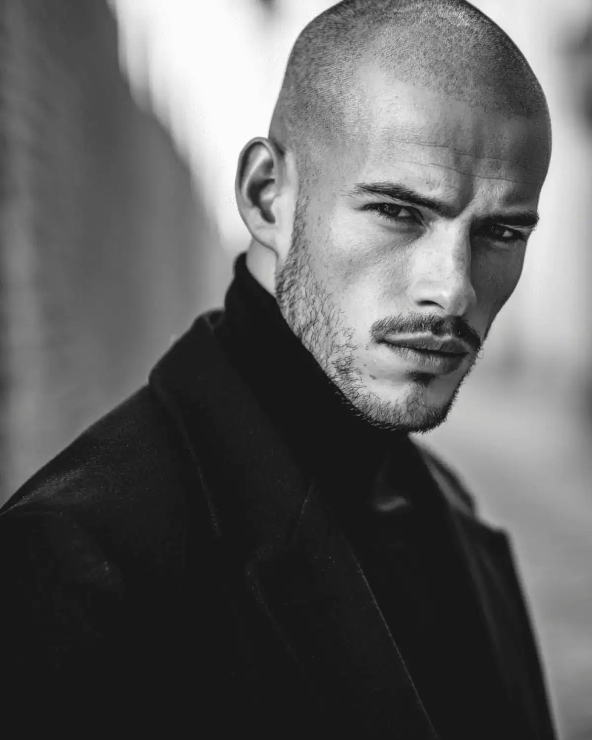 Buzz cut with heavy stubble on a man, showing a short even buzz cut paired with thicker stubble for a rugged balanced look