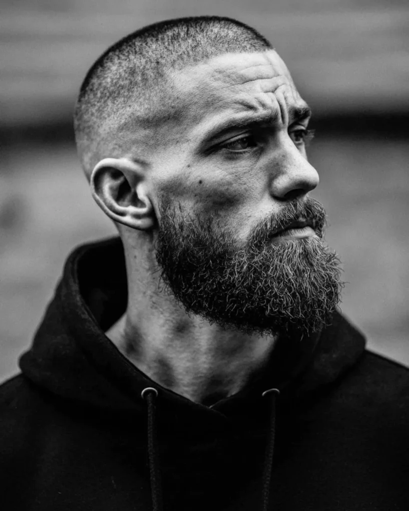 buzz cut with full beard and high skin fade, black and white side profile