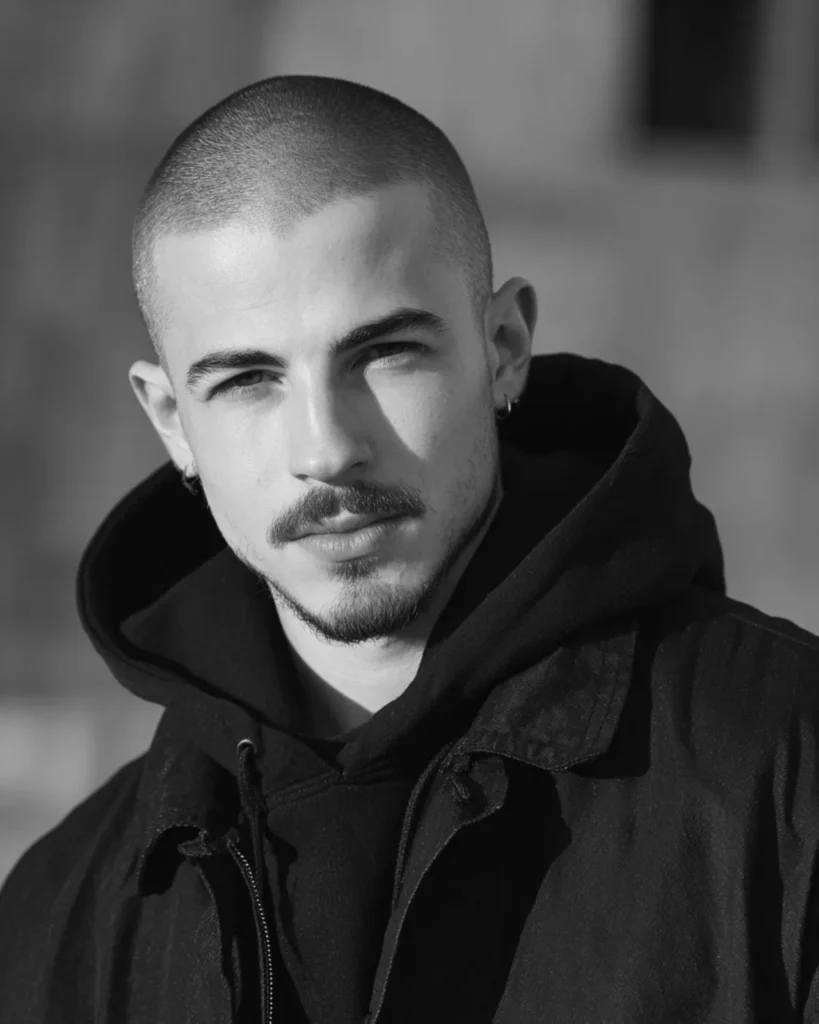 buzz cut with goatee beard and mustache on a young man, front view portrait