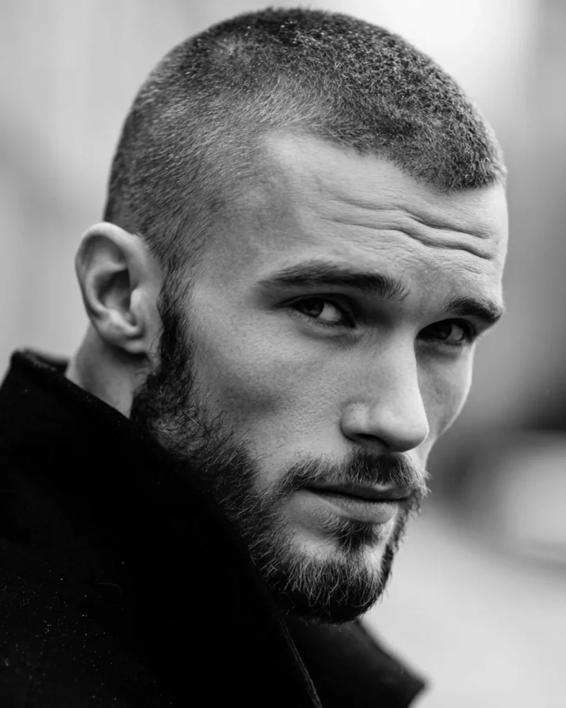 buzz cut with short boxed beard and defined cheek line, black and white three-quarter view