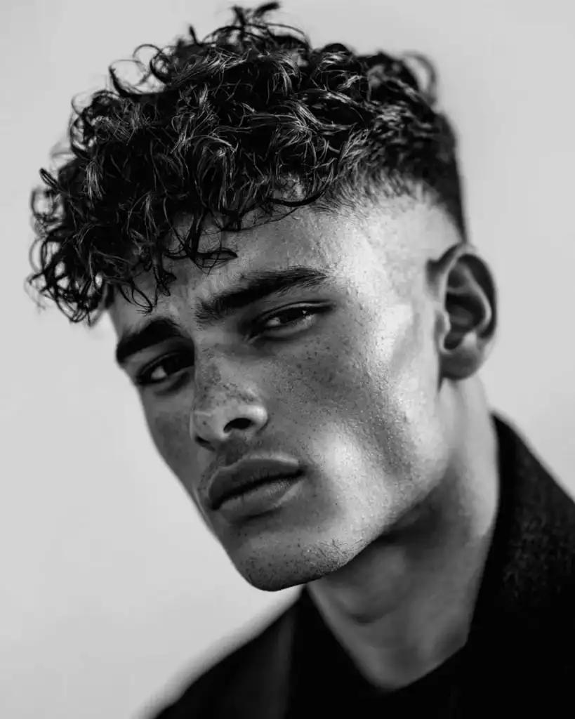 curly fringe with a high skin fade