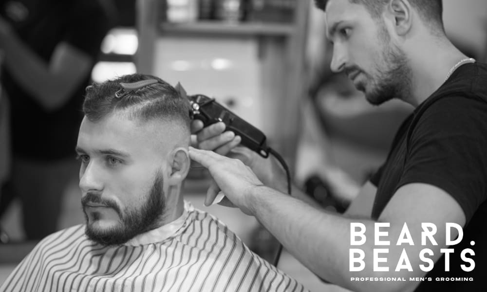 Barber giving a man a precise fade haircut—professional grooming service focused on modern men's hairstyles.