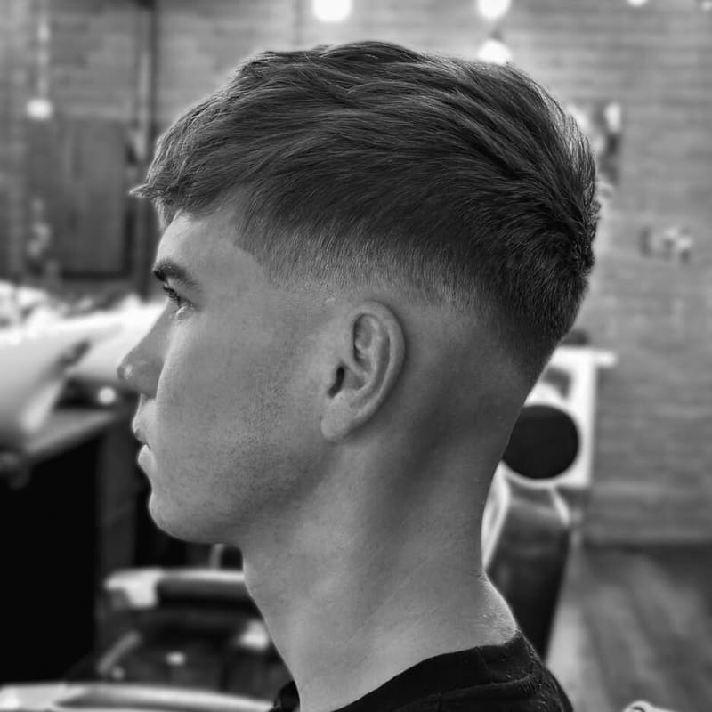 Side view of a textured crop haircut for men with small heads, featuring a clean fade and layered volume at the crown.