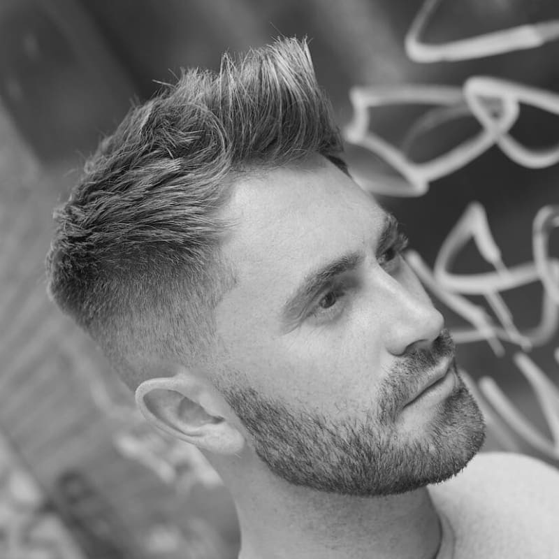Side view of a textured quiff haircut for men with small heads, featuring lifted volume at the front and tapered sides for balance.
