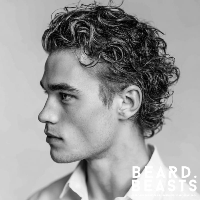 Textured slick back hairstyle for curly hair, featuring natural volume and defined curls.