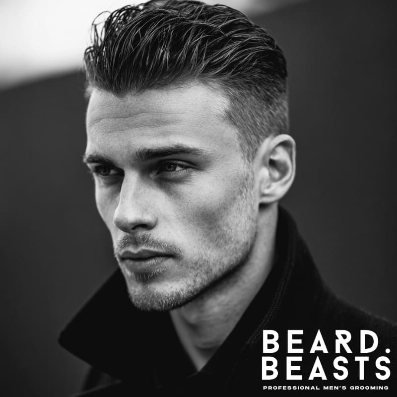 Textured wet-look slick back hairstyle for men, featuring voluminous top and sleek sides with a glossy finish.