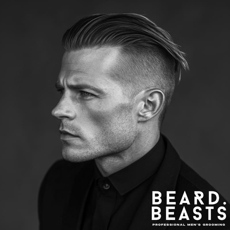 Side profile of a man with a textured haircut, featuring a disconnected undercut and slicked-back top with visible separation in black and white.