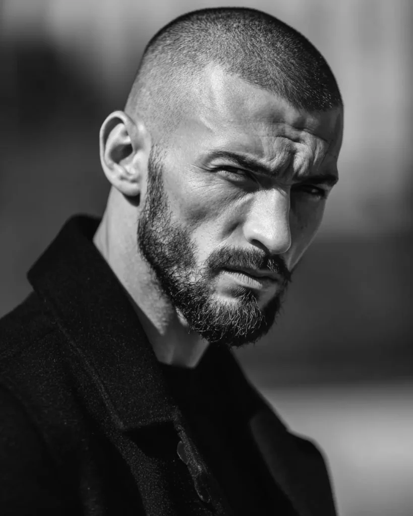 Buzz cut fade with a full beard, showing how short hair and beard weight work together.
