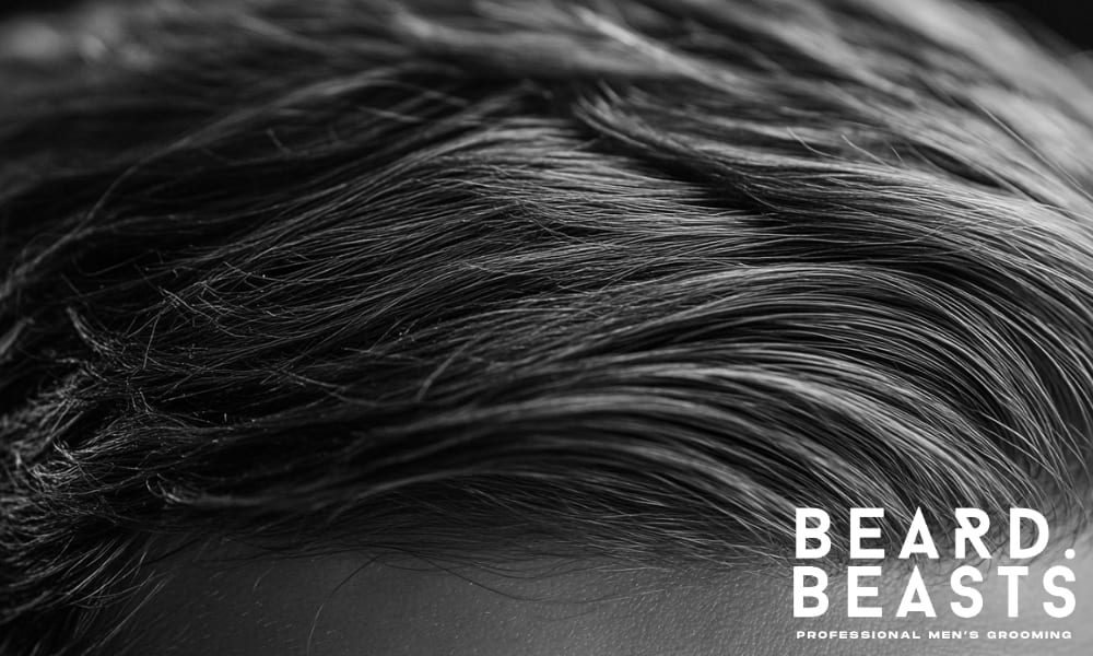 Close-up of flat men’s hair lacking volume—showing common causes like oil buildup and lack of lift.