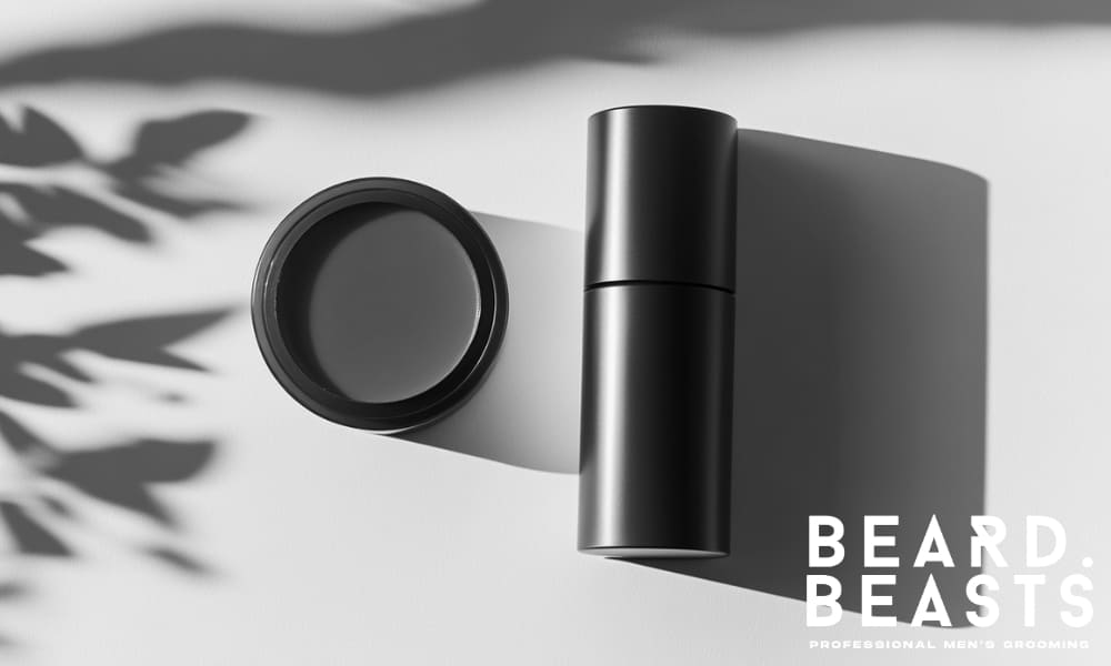 Minimalist flat-lay of men’s hair styling products, including pomade and grooming cream, symbolizing correct product selection by hair type.