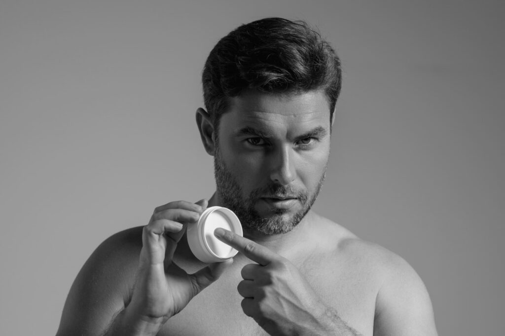 Man applying hair styling cream, demonstrating use of top men’s hair products for texture, hold, and grooming