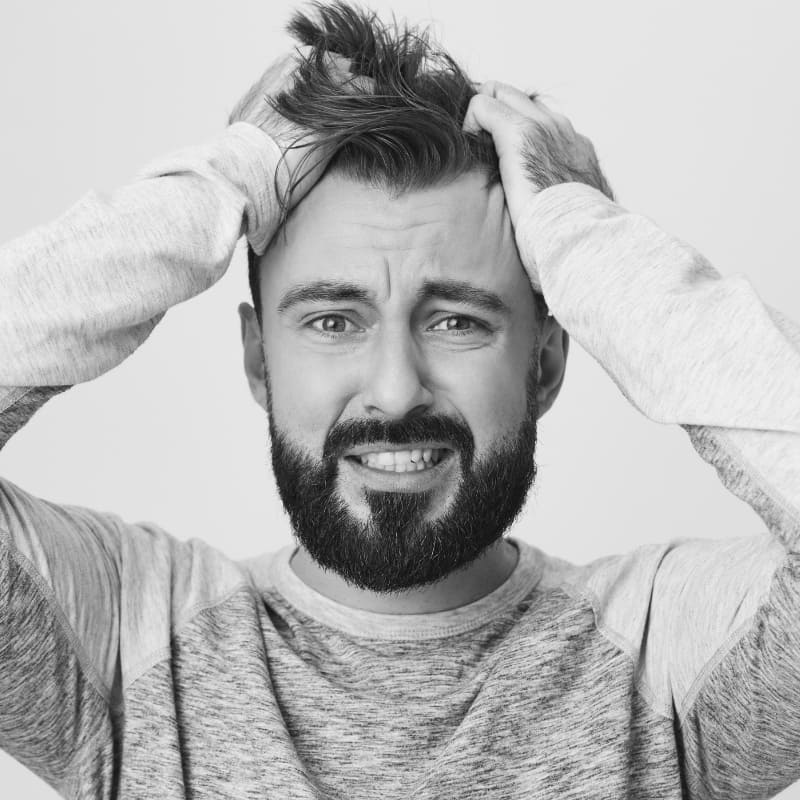 Frustrated man overthinking hairstyle and ruining messy look