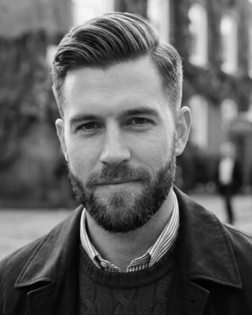 Short quiff with a beard, showing lifted short hair with tapered sides and fuller facial hair.
