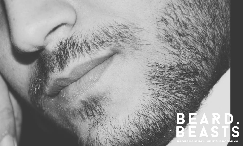 Close-up of uneven and patchy facial hair during the awkward beard stage