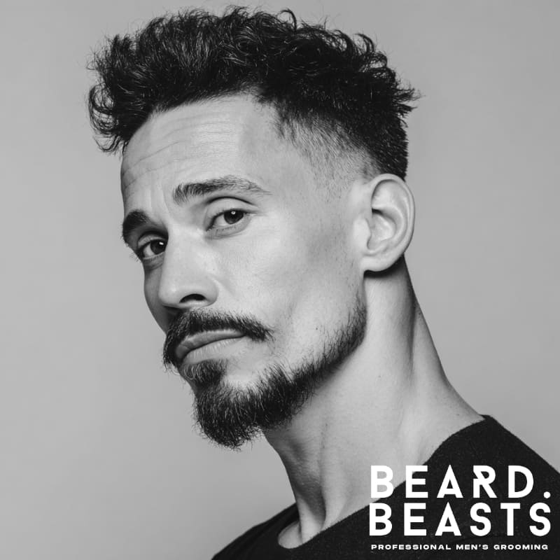 Man with a Balbo beard—floating mustache and full chin beard with clean cheeks, a strong and structured beard style for patchy cheeks.