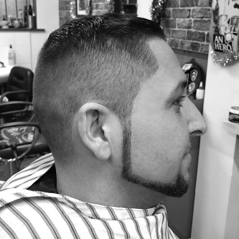 Man with a chin strap beard—sharply defined facial hair along the jawline with clean cheeks and no mustache, a bold beard style for patchy cheeks.