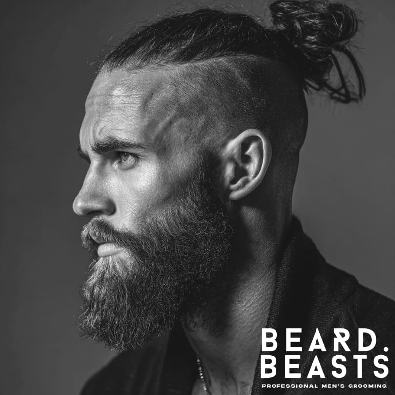 Profile of a man with a high undercut, man bun, and full beard showcasing a bold and balanced grooming style