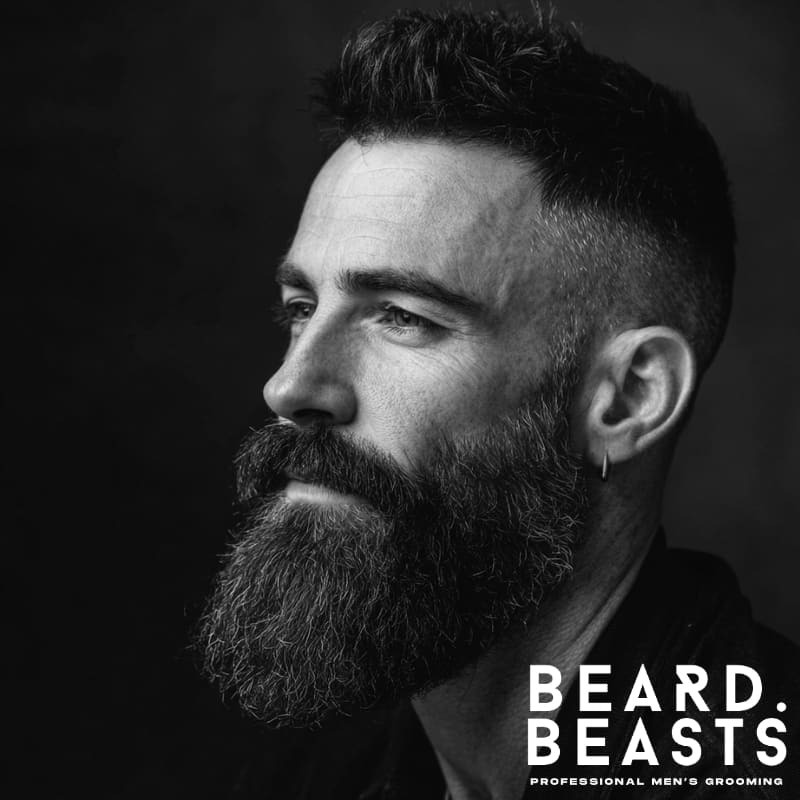 Man with an undercut quiff and long beard, featuring a voluminous textured top and full beard for balanced contrast