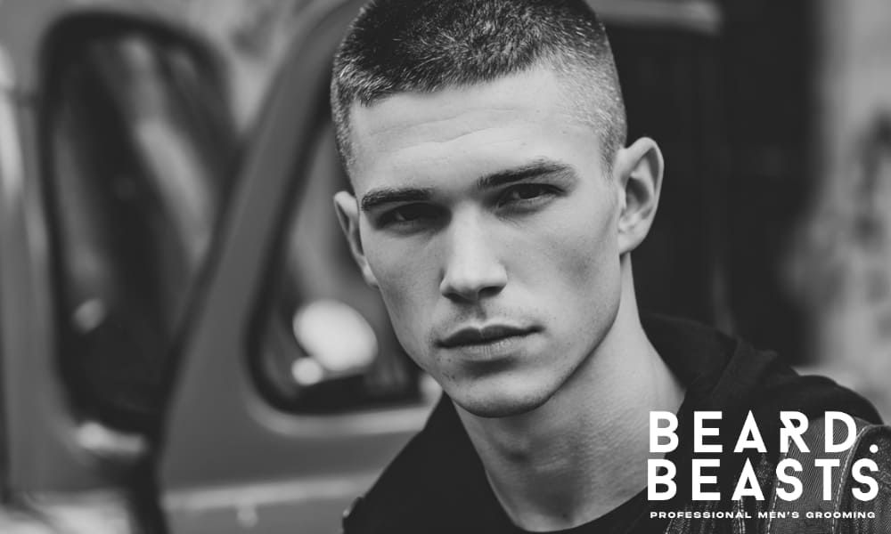 A man thoughtfully considering his crew cut options, illustrating the process of choosing the best crew cut hairstyle for one's look and features.