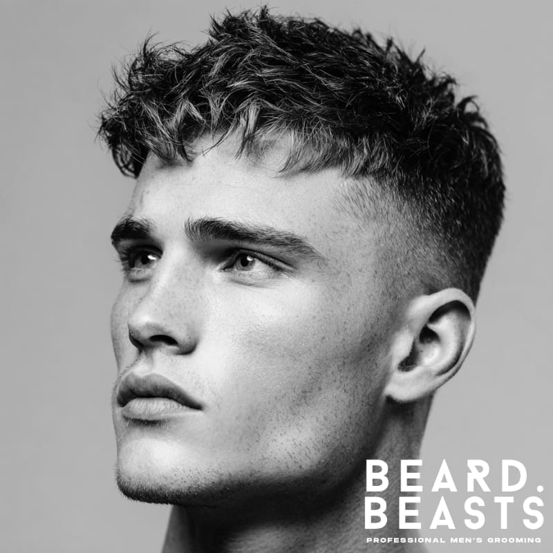 Classic skin fade textured crop hairstyle for men, featuring a clean fade on the sides and textured volume on top, creating a sharp and modern look.