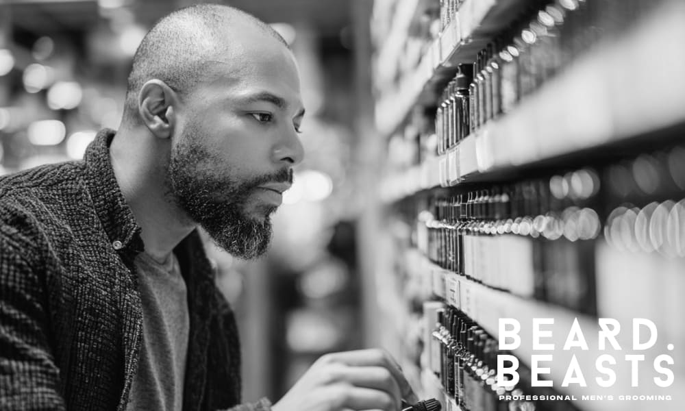 A man carefully shopping for beard oils, inspecting labels to spot harmful ingredients, ensuring high-quality grooming products for healthy skin and facial hair.