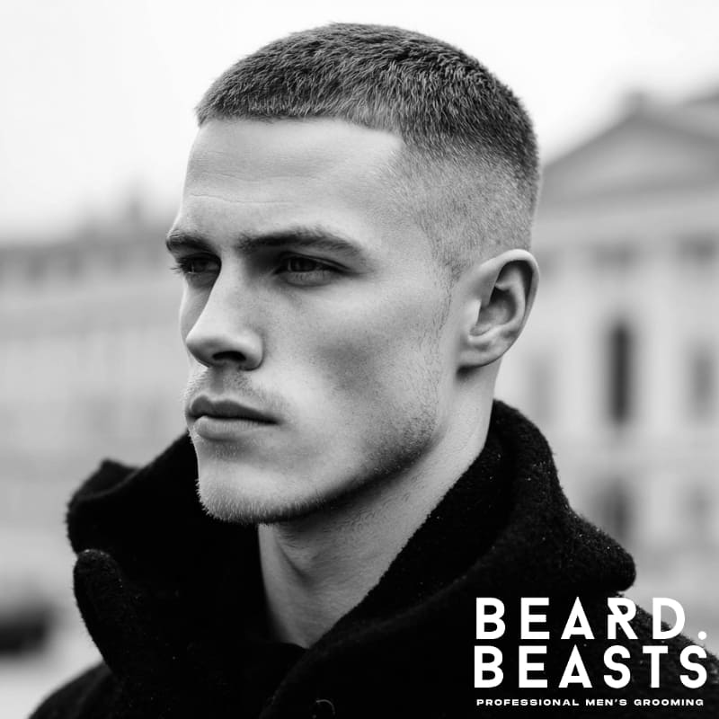 Portrait of a man showcasing a sharp, short crew cut with a clean fade on the sides, representing Beard Beasts professional men's grooming.
