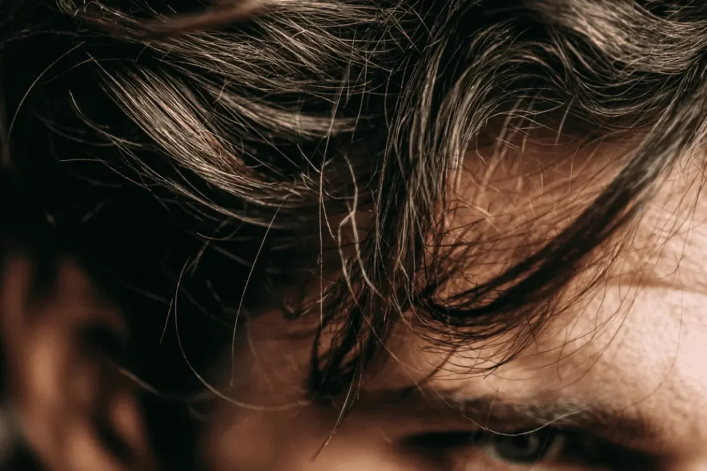 Close-up of thick men’s hair showing natural texture and movement for hair clay vs hair gel comparison